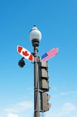Intersection street sign with direction to Canada or United stat