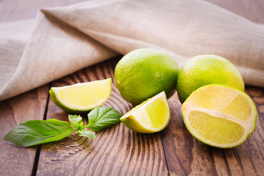 Fresh limes on wooden background.