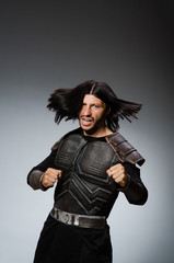 Angry warrior against dark background