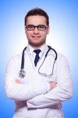 Fototapeta premium Young male doctor isolated on white