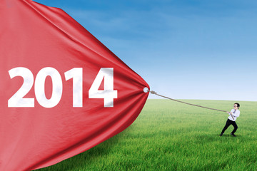 Cute asian boy pulling big banner