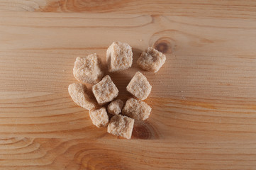pieces cane sugar on wooden background
