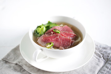 Pho beef stock soup with rice udon noodles and coriander herb