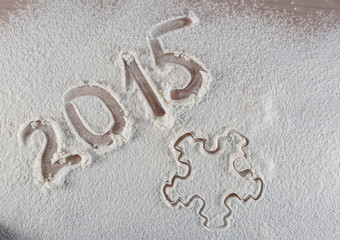 the inscription 2015 and snowflake background flour