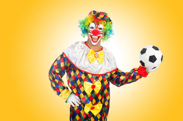 Clown with football ball on white