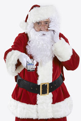 Fototapeta na wymiar Santa Claus Holding Television Remote Control