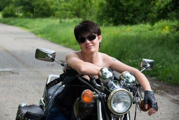 Fototapeta na wymiar Stylish girl on a bike