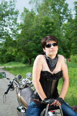 Fototapeta na wymiar Stylish girl on a bike