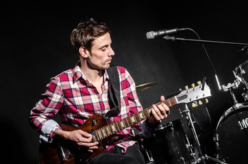 Man with guitar during concert