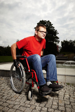 Young man on wheel chair - daily obstacles in life