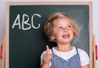 clever girl in front of black board