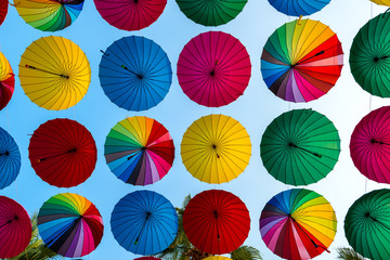 colorful umbrellas disclosed rows on sky background