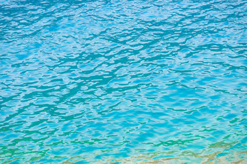 turquoise clear water with small waves