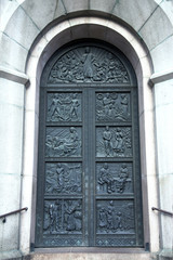 Fototapeta na wymiar Ancient ornate door to the medieval church in Tallinn, Estonia