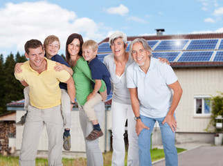 Multi Generation Family Standing Against House