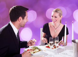 Couple Enjoying Candlelight Dinner At Restaurant