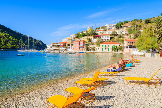 Yellow sunchairs on beach in Assos village on Kefalonia island