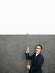 Businessman swarming up the string with poster
