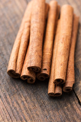 Cinnamon sticks on rustic wooden table close up