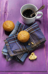 cupcake with cup of coffee on old wooden purple background