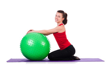 Young woman exercising with swiss ball