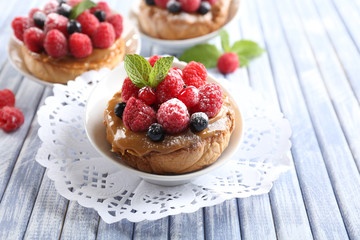 Sweet cakes with berries on table close-up