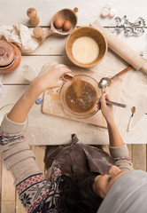 Woman baking Christmas cookies in her kitchen