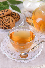 Teapot and cup of tea on table close+up