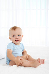 Fototapeta premium Cute baby boy on bed in room
