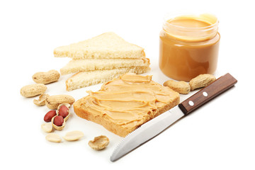 Creamy peanut butter and bread slices, isolated on white