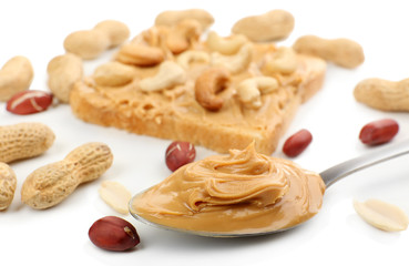 Creamy peanut butter in spoon, close-up