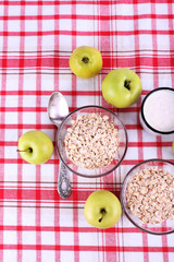 Oatmeal in bowls, mug of milk and apples