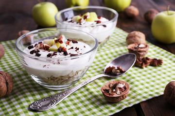 Oatmeal in bowls, yogurt, apples and walnuts
