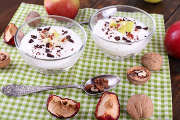 Oatmeal in bowls, yogurt, apples and walnuts