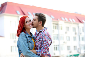 Loving couple near apartment house