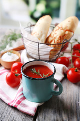 Homemade tomato juice in color mug, bread sticks, spices and
