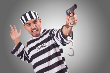 Prisoner with gun isolated on white