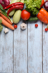 Fresh organic fruits and vegetables on wooden background