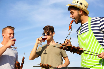 Young friends having barbecue party, outdoors