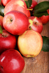 Ripe red apples on wooden background