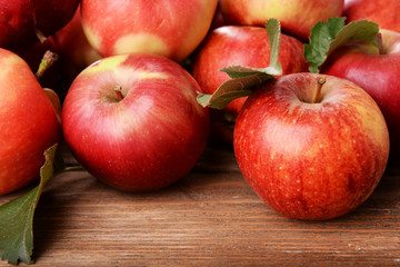 Ripe red apples on wooden background