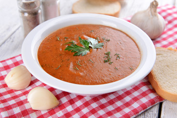Delicious lentil cream-soup on table close-up