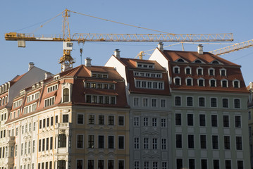 Fototapeta premium Building constructions with yellow crane on blue sky