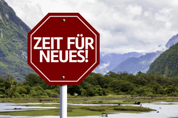 Time For New (In German) written on red road sign