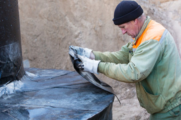 Construction worker during below ground waterproofing works