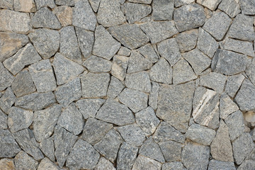 Texture of colorful stone in exposed concrete wall.