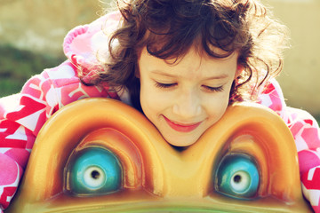 cute little girl playing and having fun on the playground, in an