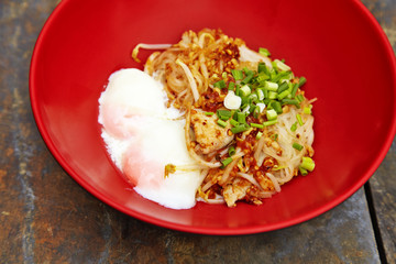 close up thai spicy pork noodle in red cup