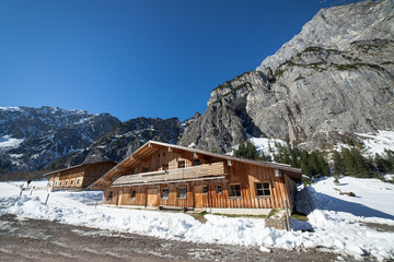 Winter landscape in a mountain valley with wooden houses