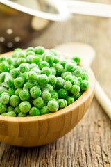 frozen peas in wooden bowl